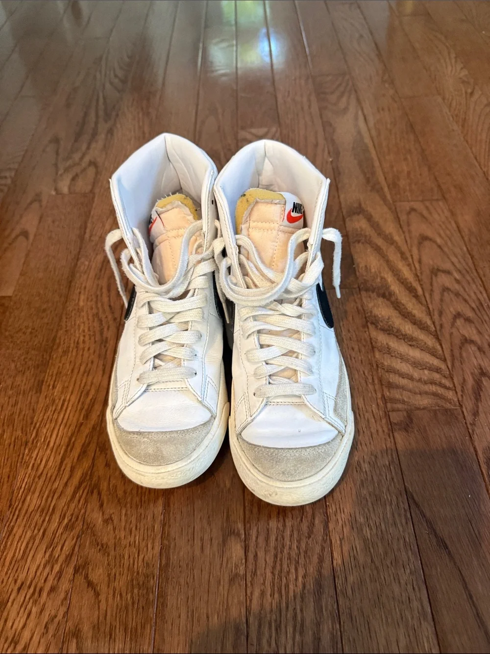 Nike White High-Top Sneakers with Black Swoosh